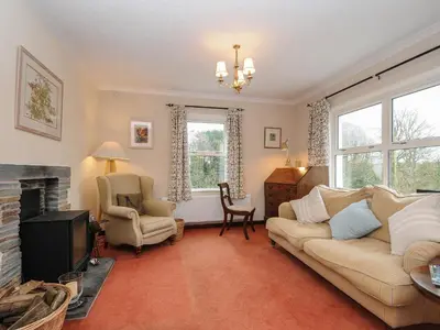 a living room with a couch and a fireplace at Kirland in Wadebridge