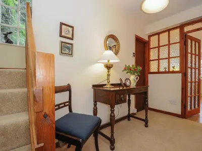 a room with a desk with a lamp and a chair at Kirland in Wadebridge