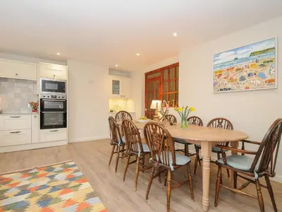 a kitchen and dining room with a table and chairs at Kirland in Wadebridge