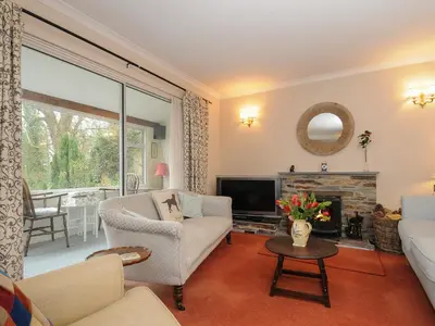 a living room with a couch and a tv at Kirland in Wadebridge