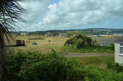 a view of a field with houses in the distance at F49 Junesta, Riviere Towans in Hayle