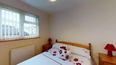 a bedroom with a bed and a window at F43 Hazebrook, Riviere Towans in Hayle
