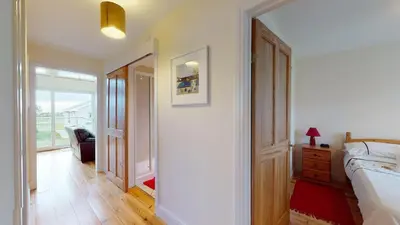 a bedroom with a bed and a room with a window at F43 Hazebrook, Riviere Towans in Hayle