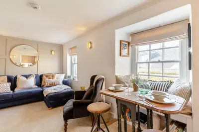 a living room with a blue couch and a table at 2 Bed in St. Ives oc-p00568 in St Ives