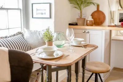 a wooden table with two cups and a wine glass at 2 Bed in St. Ives oc-p00568 in St Ives