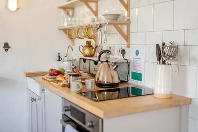 a kitchen counter with a tea kettle and fruits on it at 2 Bed in St. Ives oc-p00568 in St Ives
