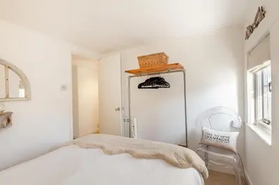 a white room with a bed and a chair at 2 Bed in St. Ives oc-p00568 in St Ives