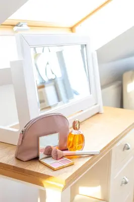 a bag sitting on a table with a mirror at Carbis Bay - Luxury 3 Bed Penthouse Apartment with Sea Views Parking Sauna Balcony in Carbis Bay