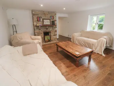 a living room with a couch and a coffee table at Sunnyvale Cottage in Penzance