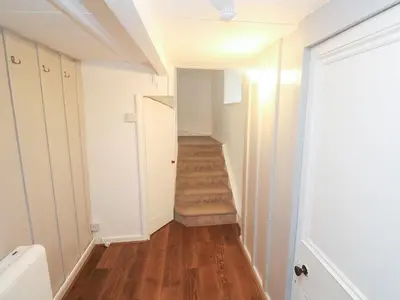 a hallway with a stairway with a stair case at Sunnyvale Cottage in Penzance