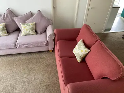 two chairs and a couch in a living room at Light and bright 3 bedroom bungalow in Cornwall in Liskeard