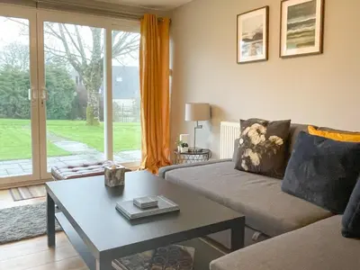 a living room with a couch and a table at Atlantic Lodge in Saint Columb Major