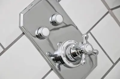 a chrome shower faucet in a glass mirror at WALK TO THE BEACH, spacious cottage with sea views in St Merryn