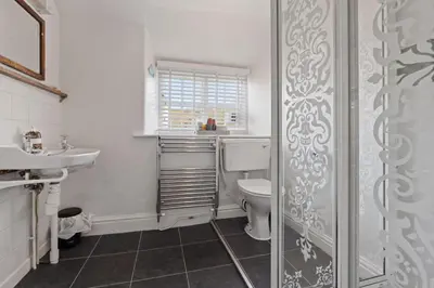 a bathroom with a toilet and a sink at Myrtle Cottage Boscastle in Boscastle
