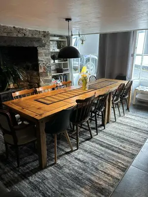 a long wooden table and chairs in a room at Myrtle Cottage Boscastle in Boscastle
