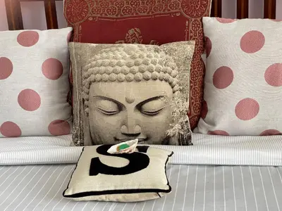 a pillow on a bed with a statue of a head at Seaforth St Ives in St Ives