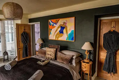 a bedroom with a king sized bed with a mask on it at Seaforth St Ives in St Ives