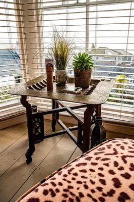 a table with potted plants on it in front of a window at Seaforth St Ives in St Ives