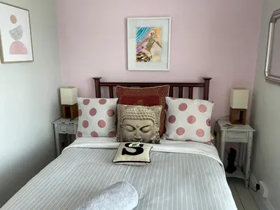 a bedroom with a bed with a head on it at Seaforth St Ives in St Ives