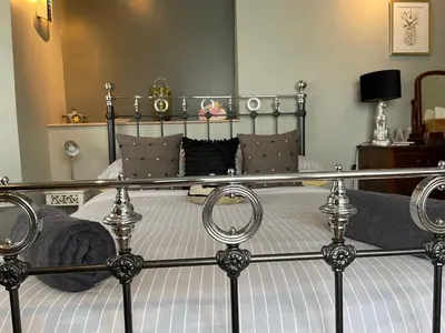 a bedroom with a bed with a metal bed frame at Seaforth St Ives in St Ives