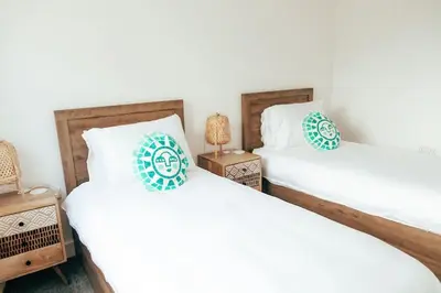 two beds sitting next to each other in a bedroom at The Hideout - Newquay - Fully Stocked Eco Escape in Newquay