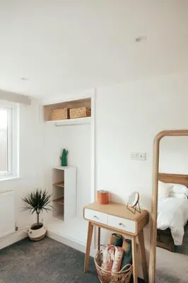 a bedroom with a bed and a table and a desk at The Hideout - Newquay - Fully Stocked Eco Escape in Newquay