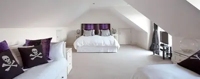 a white room with a bed and a couch at Stargazers in Saint Mawes