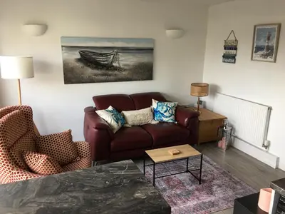 a living room with a couch and a table at Torpoint - Apartment - Sleeps4 - Seaside - Parking in Torpoint