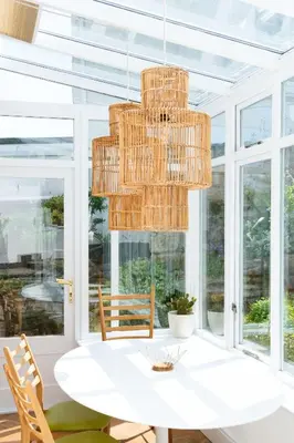 a dining room with a white table and a chandelier at Sands Studio and Samphire Studio in St Ives