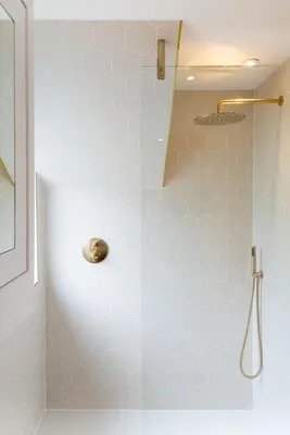 a shower with a glass door in a bathroom at Sands Studio and Samphire Studio in St Ives