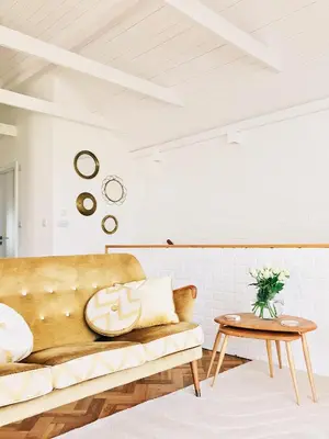 a living room with a couch and a table at Sands Studio and Samphire Studio in St Ives