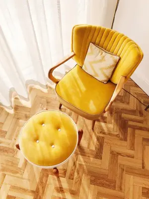 a yellow chair and a ottoman in a room at Sands Studio and Samphire Studio in St Ives