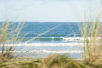 a view of the ocean from a beach with waves at Towans Retreat, Hayle in Hayle