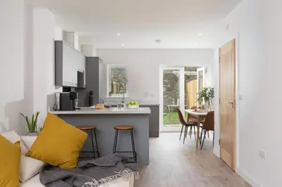 a kitchen and living room with a couch and a table at Towans Retreat, Hayle in Hayle