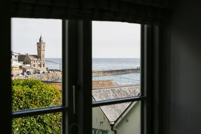 a view of the ocean from a window at Joinery Cottage in Porthleven