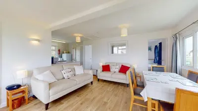 a living room with a couch and a table at F15 Brian View, Riviere Towans in Hayle