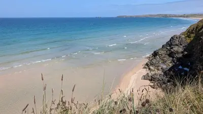 a sandy beach with the ocean in the background at F67 Ischia, Riviere Towans in Hayle