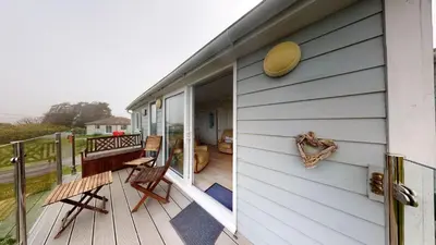 a porch of a house with chairs on it at F75 Bronvellan, Riviere Towans in Hayle