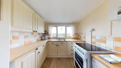 a kitchen with a sink and a stove at F75 Bronvellan, Riviere Towans in Hayle