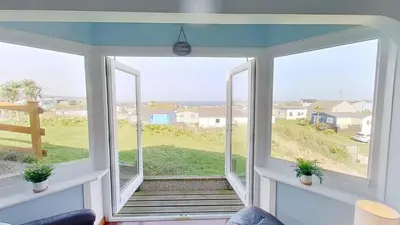 a room with a window with a view of the ocean at F74 Chyandour, Riviere Towans in Hayle