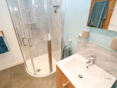a bathroom with a shower and a sink at Chilowan in Tintagel