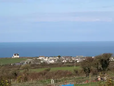 a group of houses on a hill near the ocean at Chilowan in Tintagel