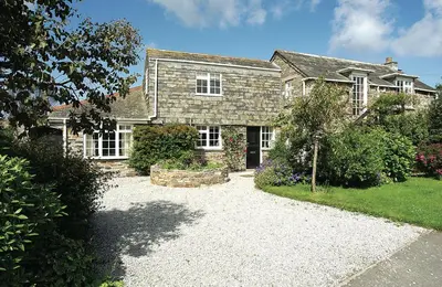 a large brick house with a driveway in front of it at Little Pityme in Wadebridge