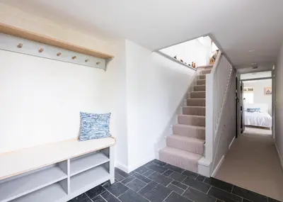a staircase in a house with white walls and a stair case at Little Pityme in Wadebridge