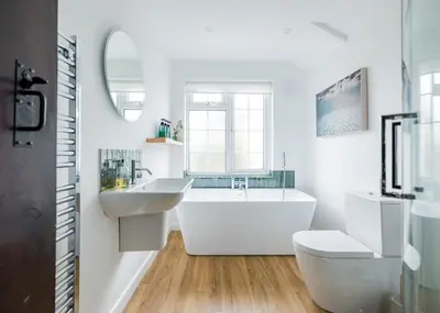 a bathroom with a tub and a sink and a toilet at Little Pityme in Wadebridge