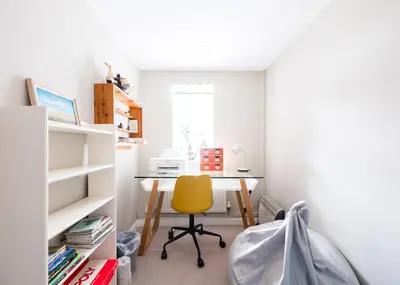 a desk with a yellow chair in a room at Little Pityme in Wadebridge