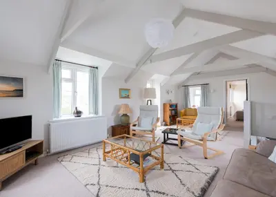 a living room with a couch and a table at Little Pityme in Wadebridge