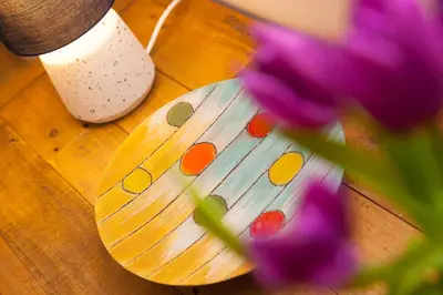 a wooden table with a purple flower in front of a wooden table with a purple at Dream Achieved in St Ives