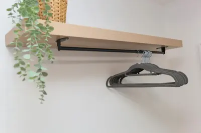 a shelf with a hose on a wall with a plant at Dream Achieved in St Ives