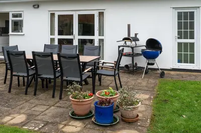 a patio with a table and chairs and a grill at Finest Retreats - Sunny Nook in Padstow